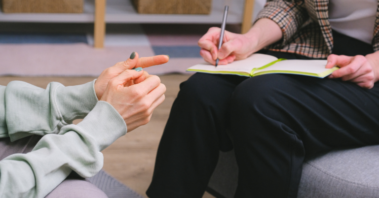 A woman in therapy with her addiction treatment therapist using evidence-based addiction treatment methods