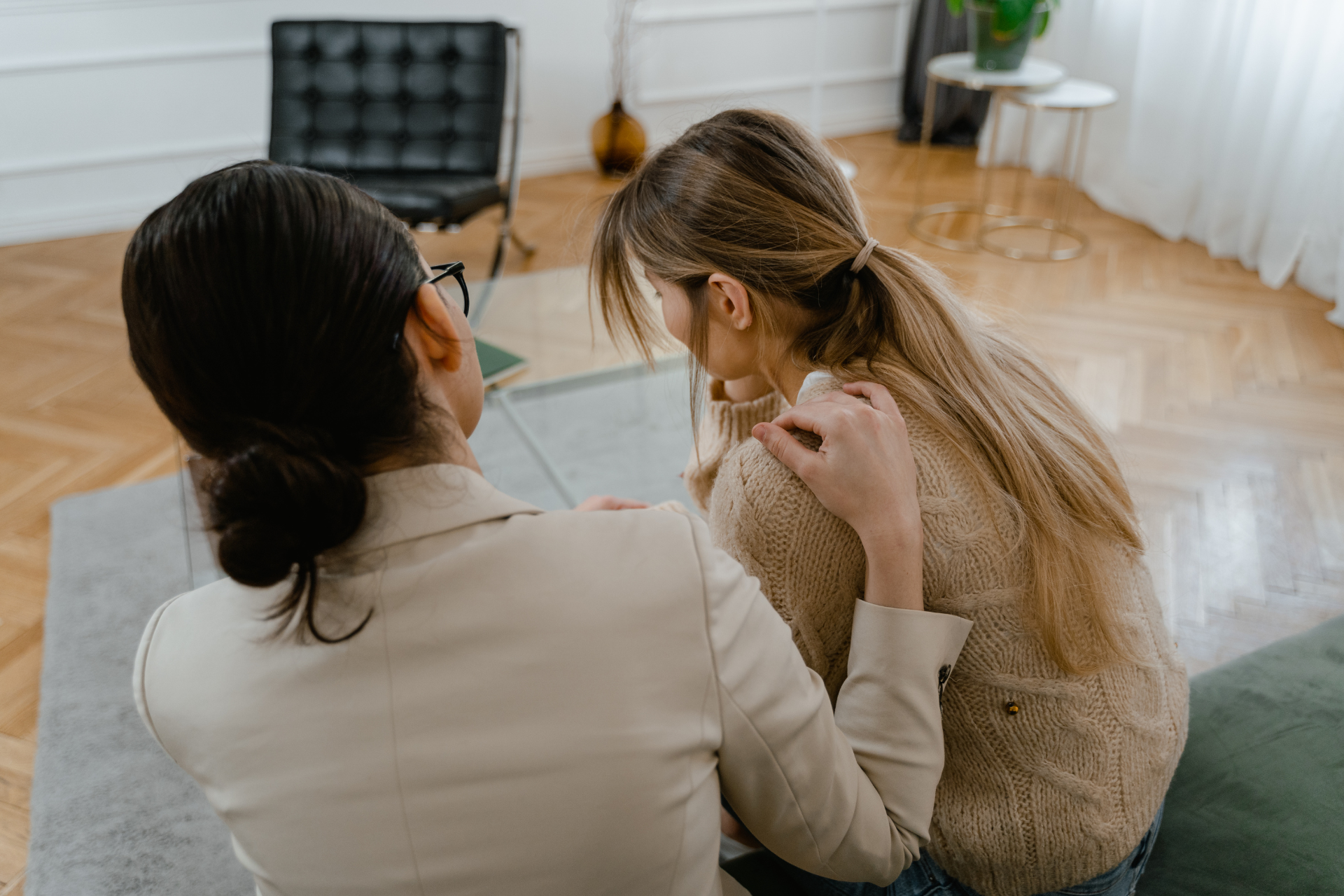 A woman being comforted while getting treatment for paranoid personality disorder.