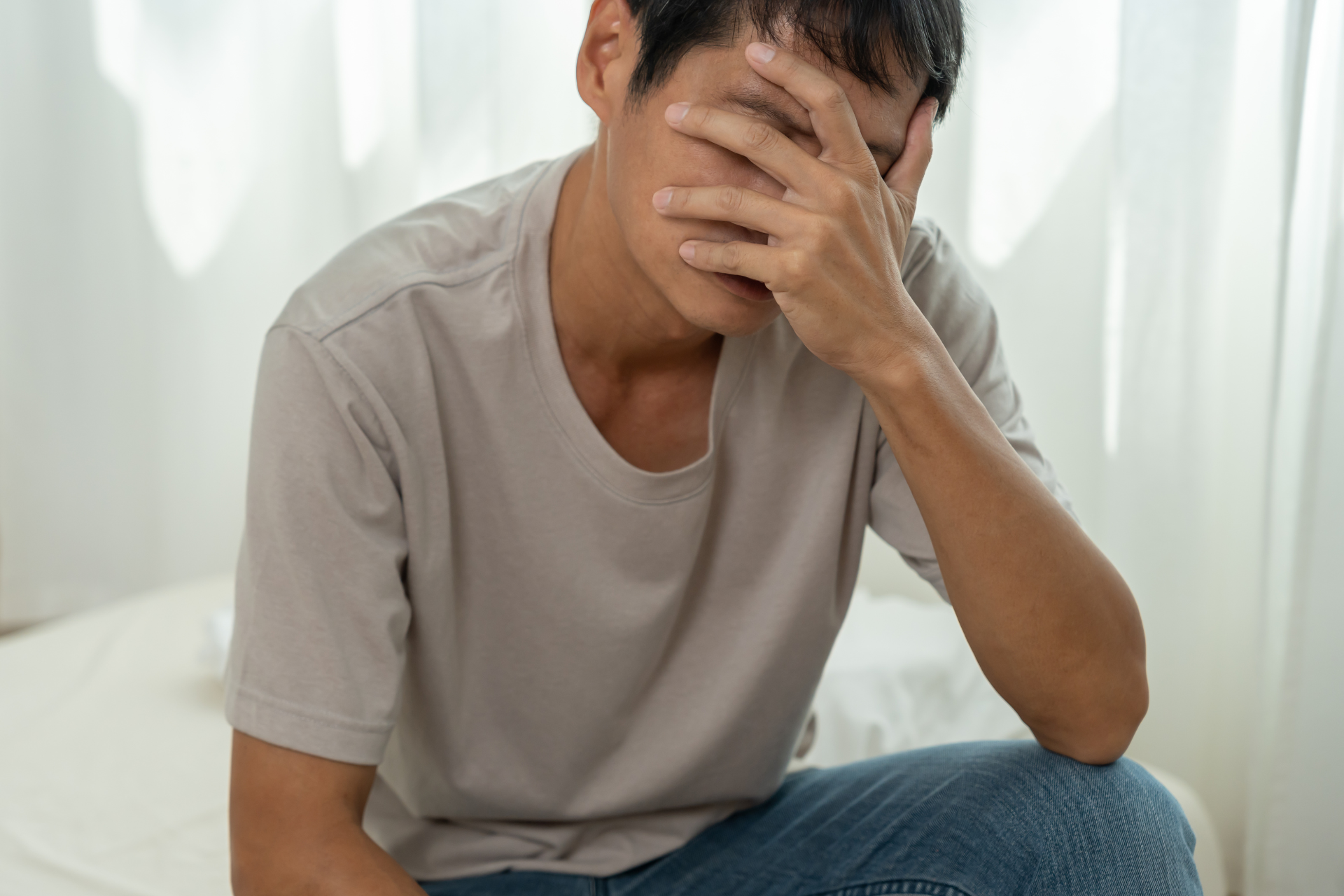 A man with Schizoid Personality Disorder resting his head in his hand.