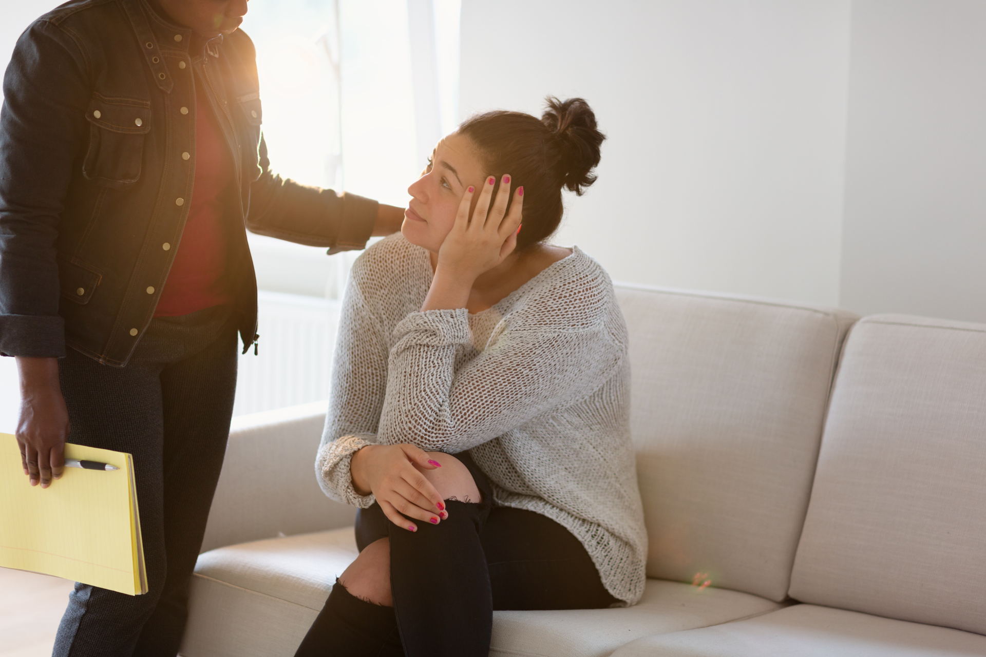 A woman being comforted. She is getting treatment for schizophrenia.