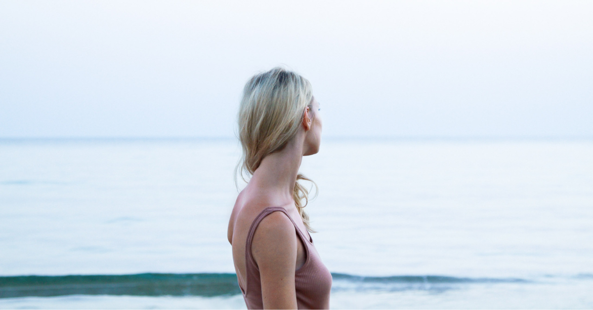 A woman gazing out at the ocean, working to find balance with borderline personality disorder.