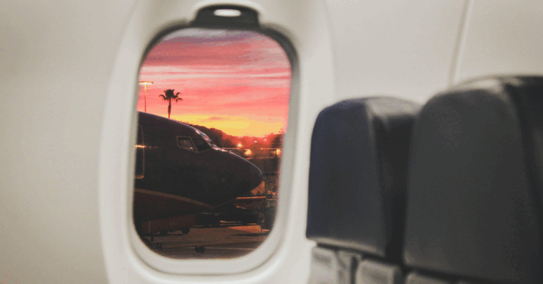 Point of view of a person who is using FMLA for rehab looking out a plane window as they fly to Milton Recovery Centers