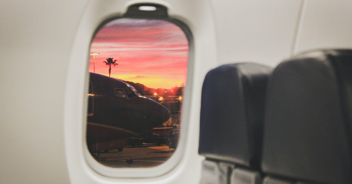 Point of view of a person who is using FMLA for rehab looking out a plane window as they fly to Milton Recovery Centers
