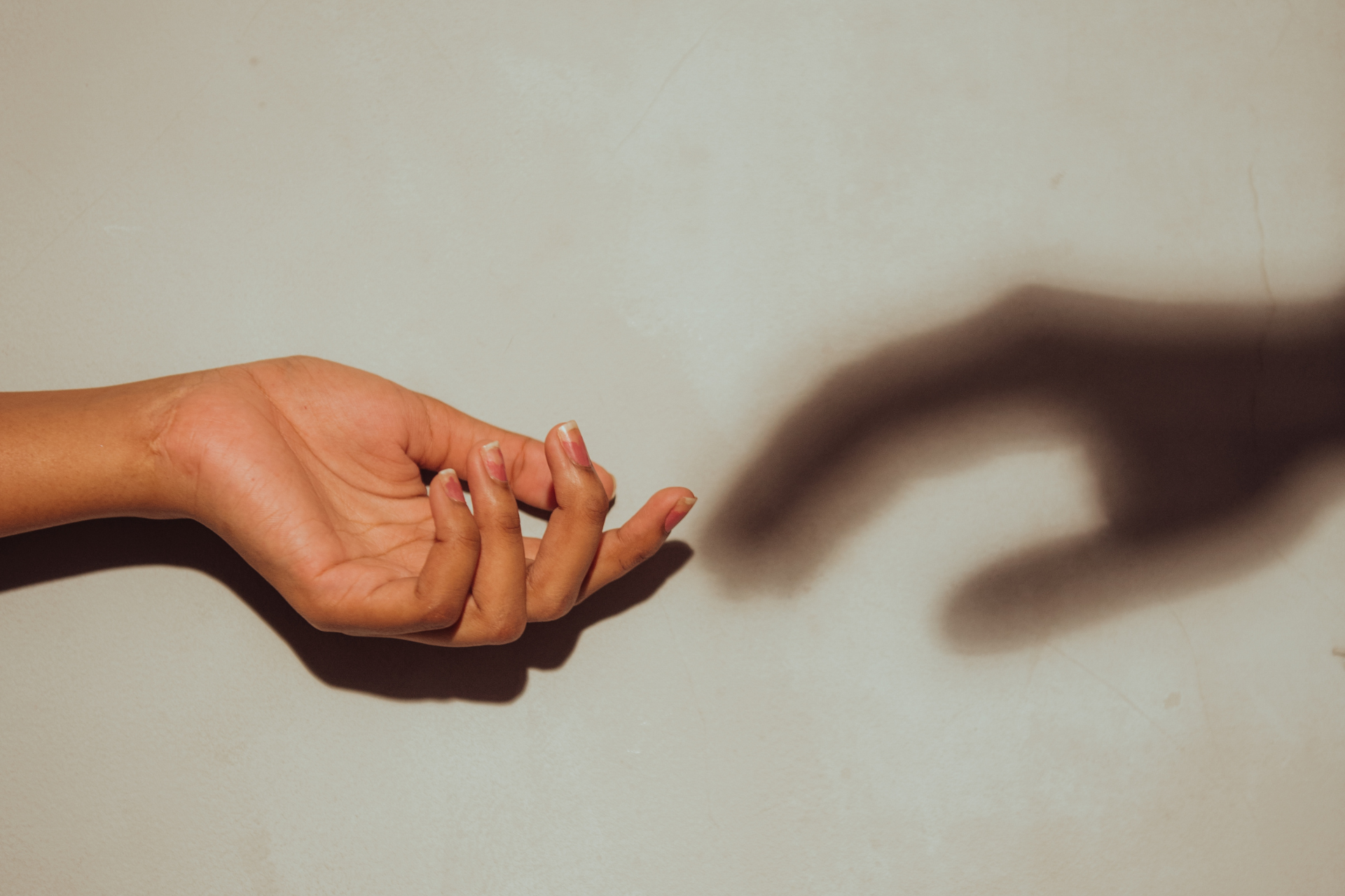 A patient reaching toward a shadow in SUD IOP at Milton. SUD Intensive Outpatient Program