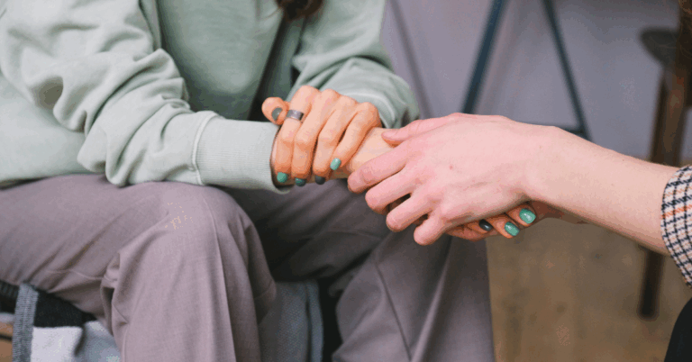 A woman being comforted by a therapist in treatment for OCD