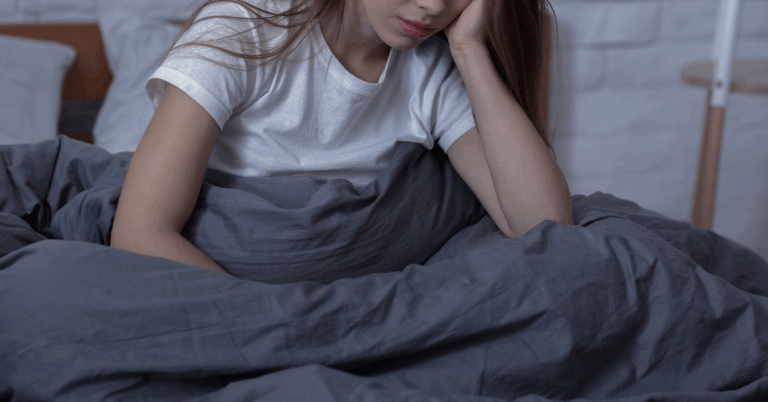 A woman with her head in her hand struggling with SAD