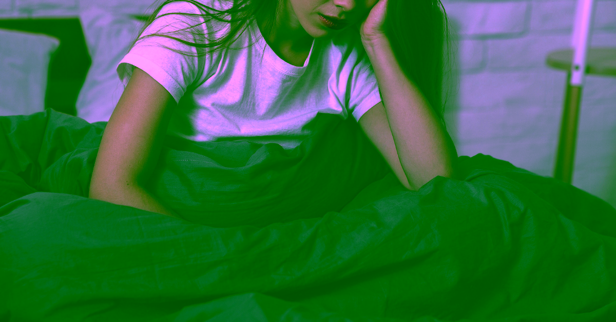 A woman with her head in her hand struggling with SAD