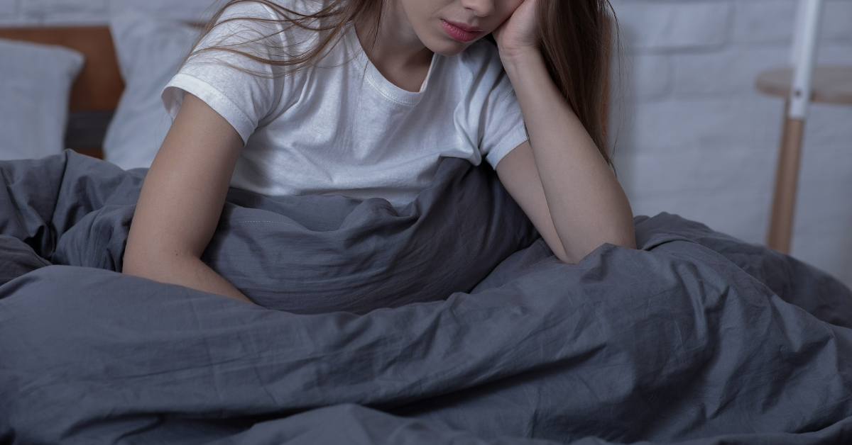 A woman with her head in her hand struggling with SAD