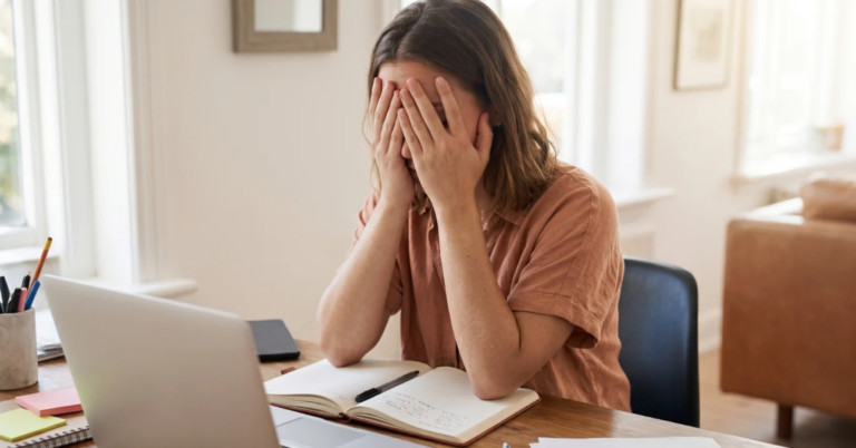 Girl covering her face stressed at the computer, Does Insurance Cover Partial Hospitalization Programs